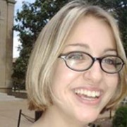 Smiling woman with glasses and a blonde bob haircut 